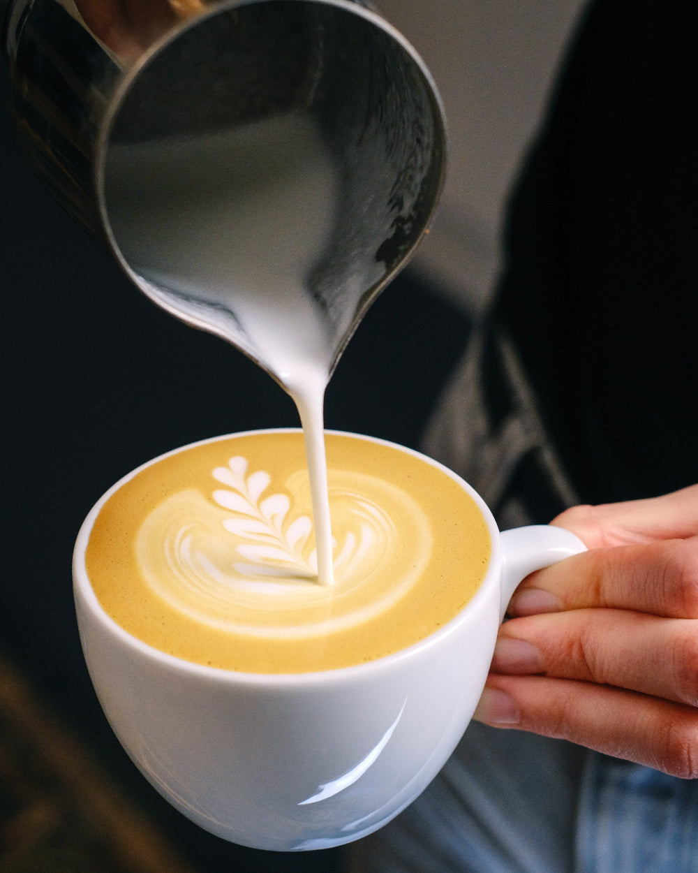 Steamed milk poured into a coffee